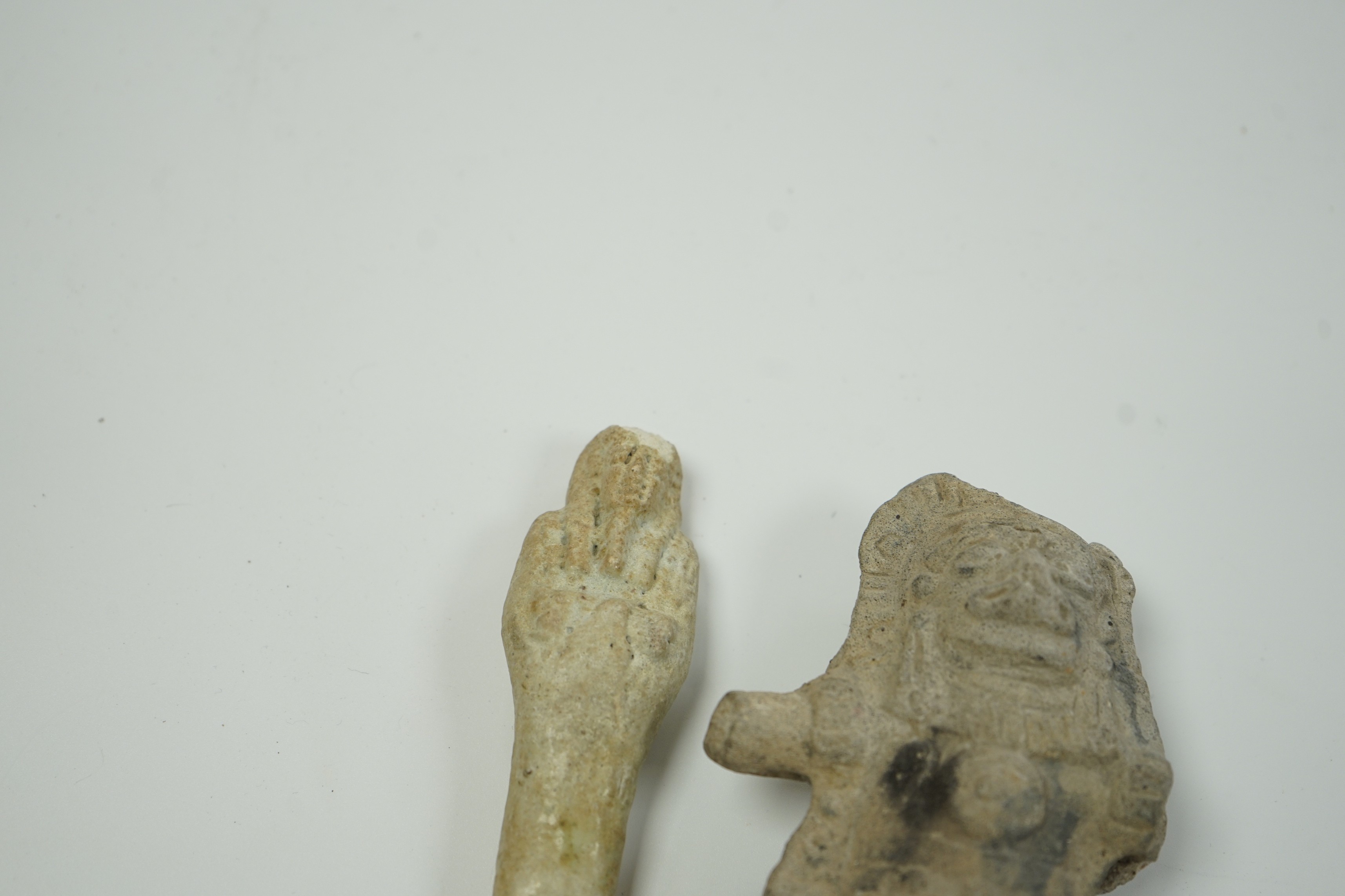 An Egyptian cream faience ushabti and a pre-Columbian pottery figure, 10cm high